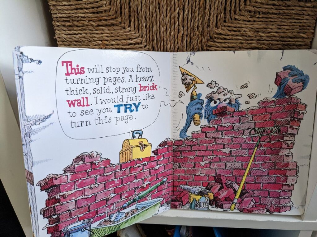 Grover building a brick wall so you cannot turn the page the the monster at the end of the book.